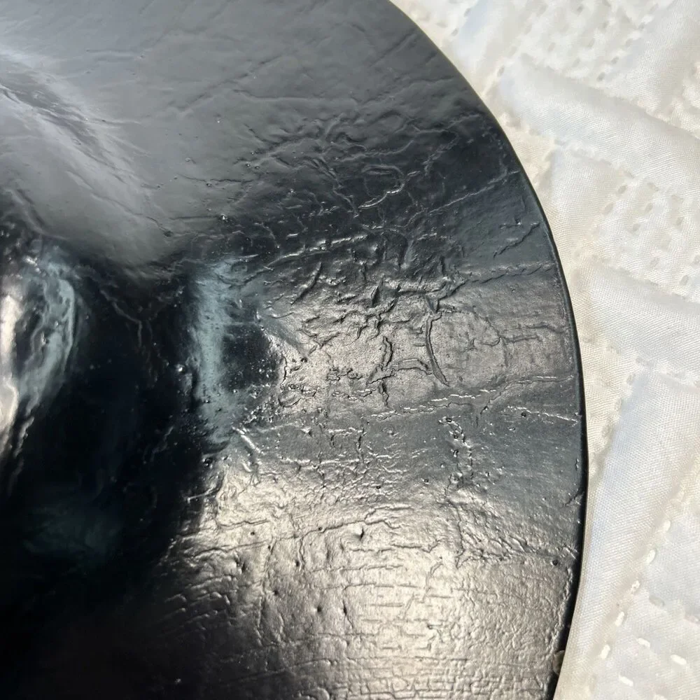 Glass bowl features an asymmetrical shape with a striking black and gold crackle